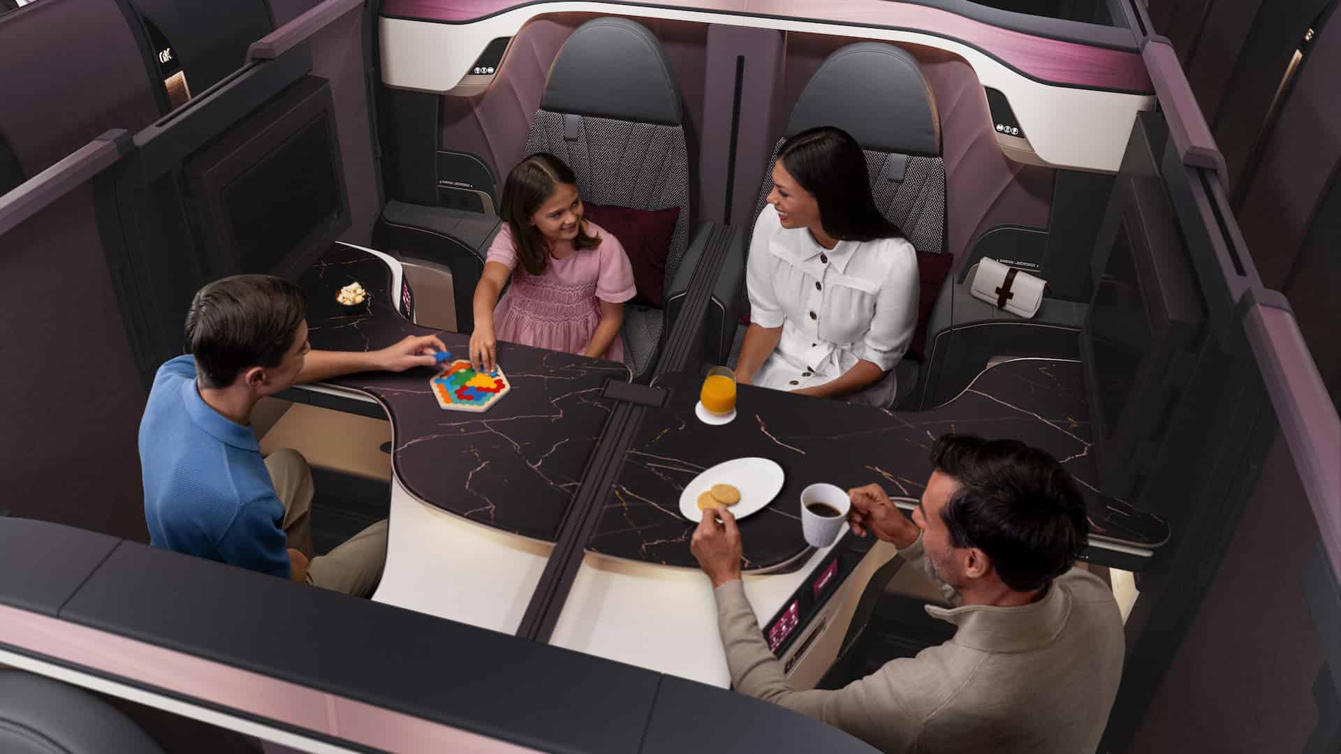Family enjoying luxury business class airplane suite with private seating and shared table. Parents and children relax together in a premium airline cabin, featuring spacious seats, modern design, and in-flight dining with snacks and drinks. Ideal example of family-friendly business class travel experience with comfort, privacy, and social seating layout.