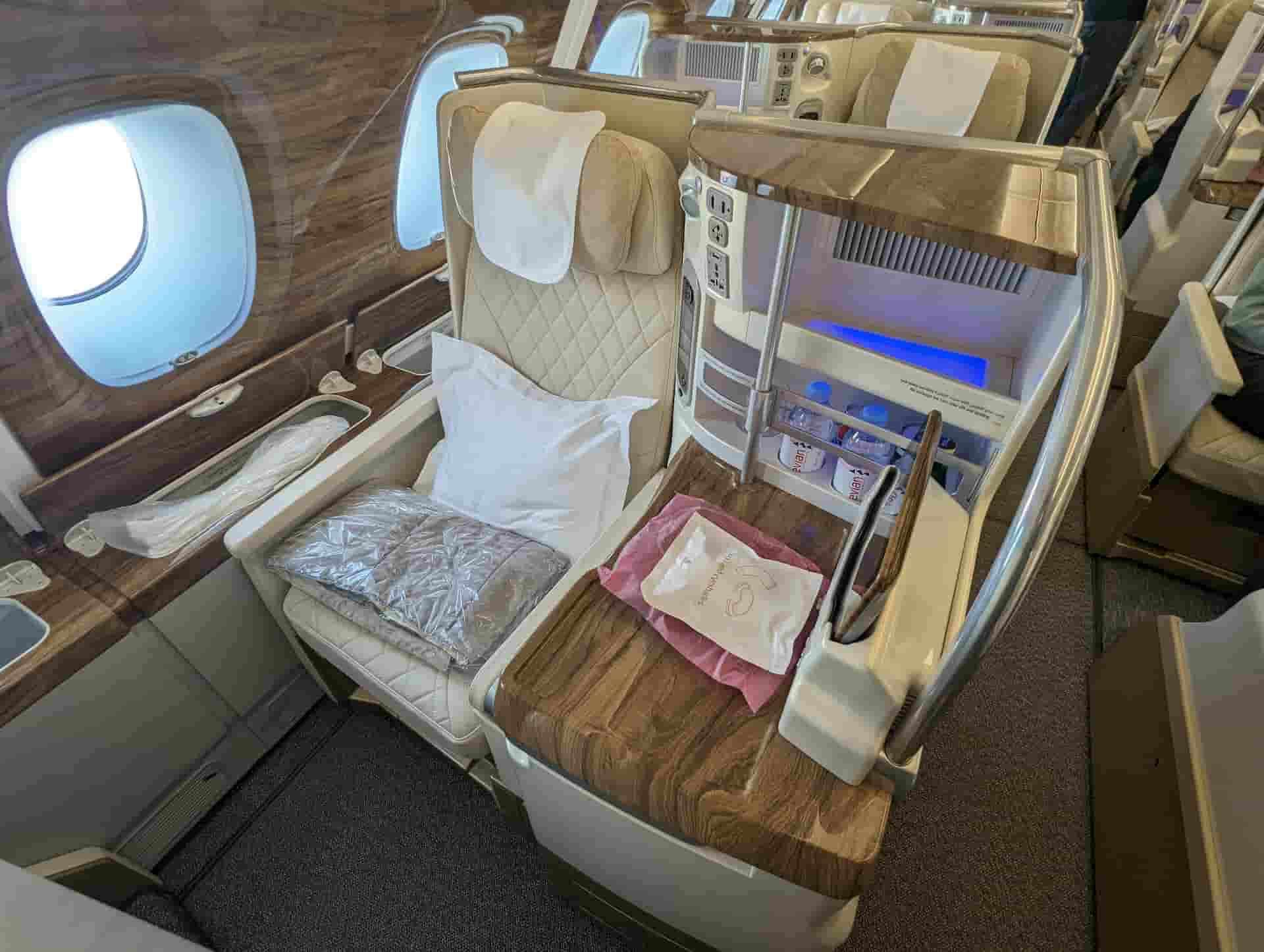 Business class seat with amenity kit beside the cabin window