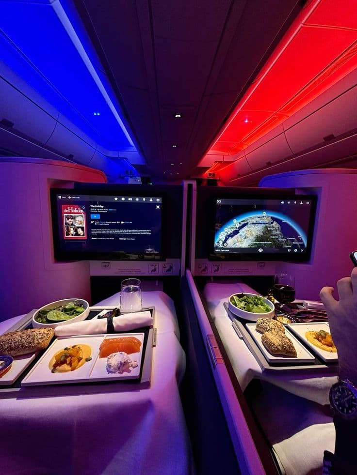 How much more expensive is business class: dinner served between two lie-flat seats in a business class cabin