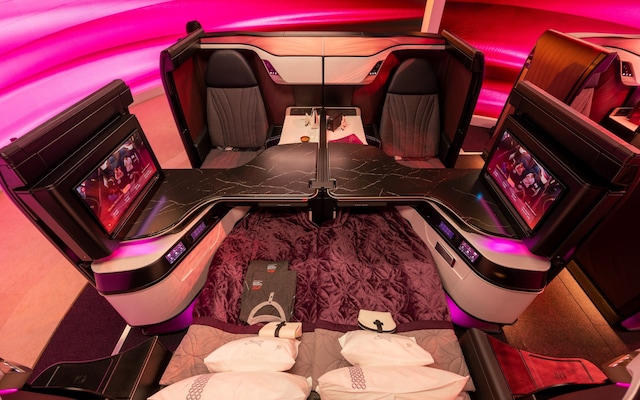 Qatar Airways Qsuite business class suite with a closing privacy door