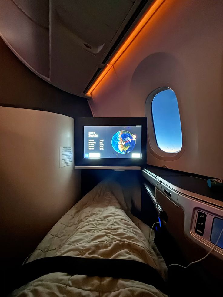 Lie-flat business class bed made up for an overnight flight, the comfort the price premium buys