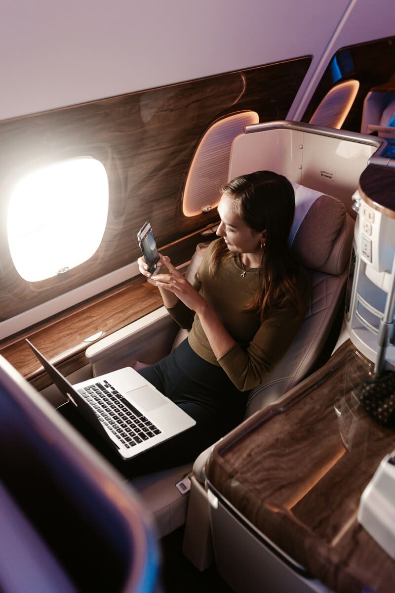 Woman working in business class seat on flight to Europe