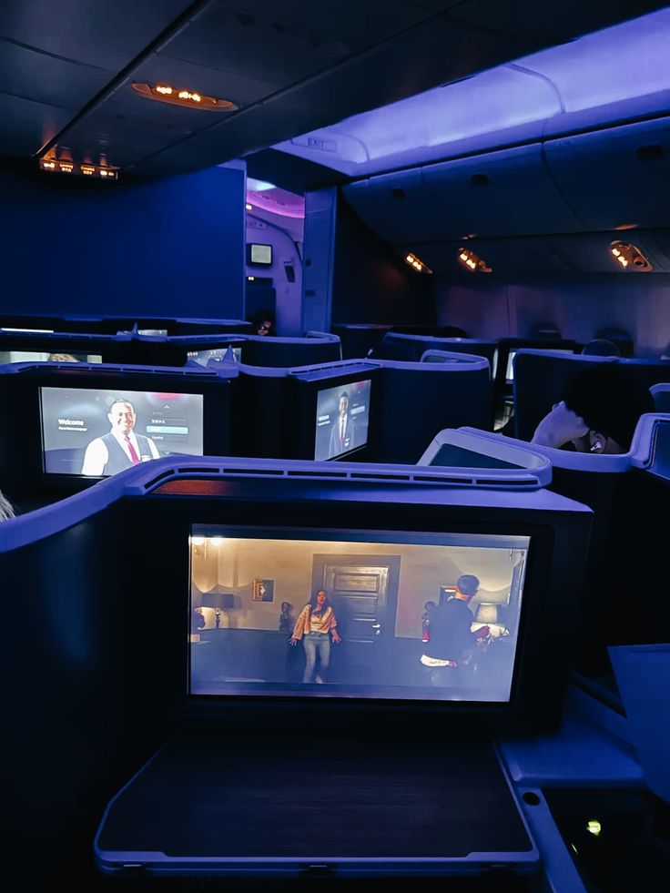 Passenger watching a film in a business class seat on an overnight flight